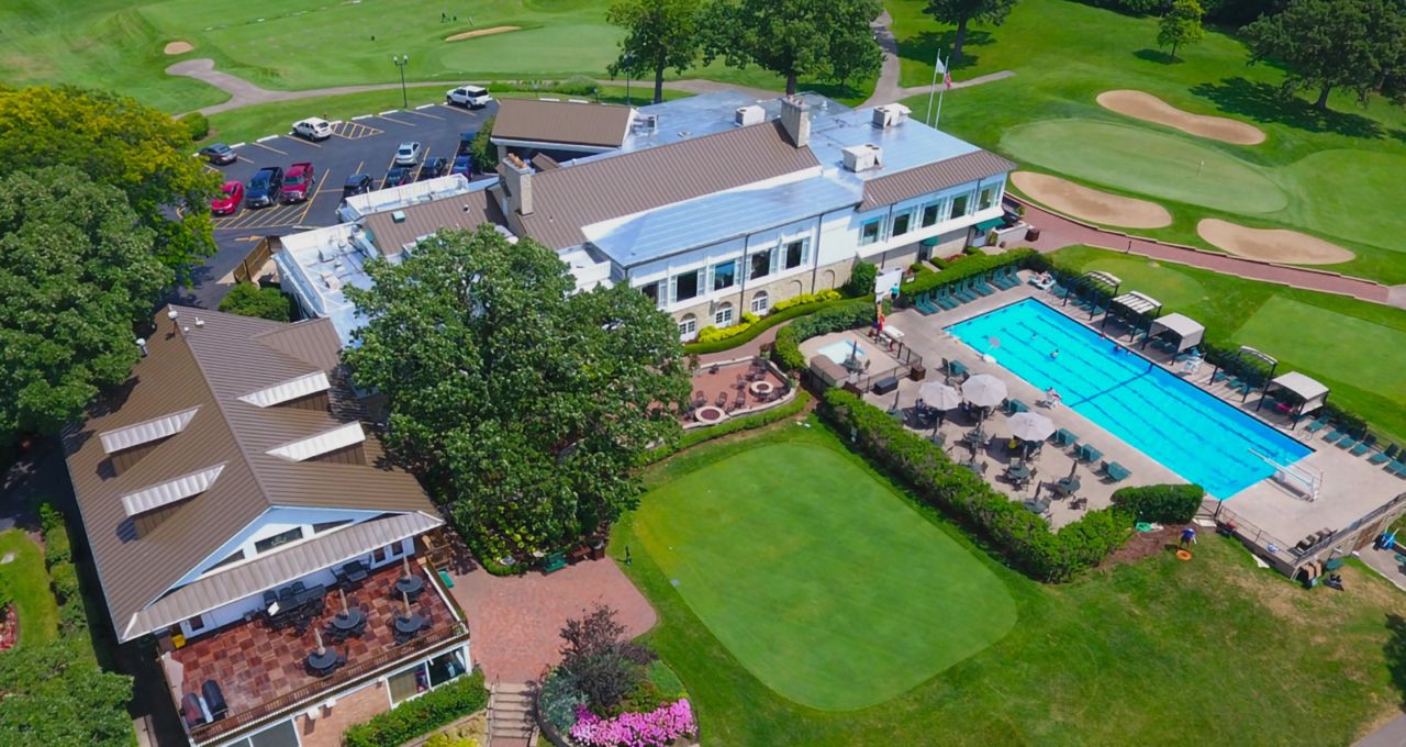 Aerial view of the Elgin Country Club clubhouse, pool and practice green